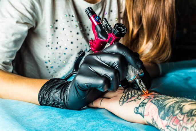 Can permanent tattoos be safely removed, and if so, is the removal process painful?